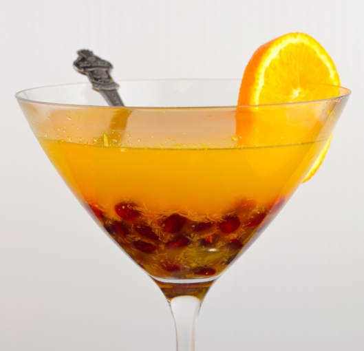 citrus arak cocktail with pomegranates